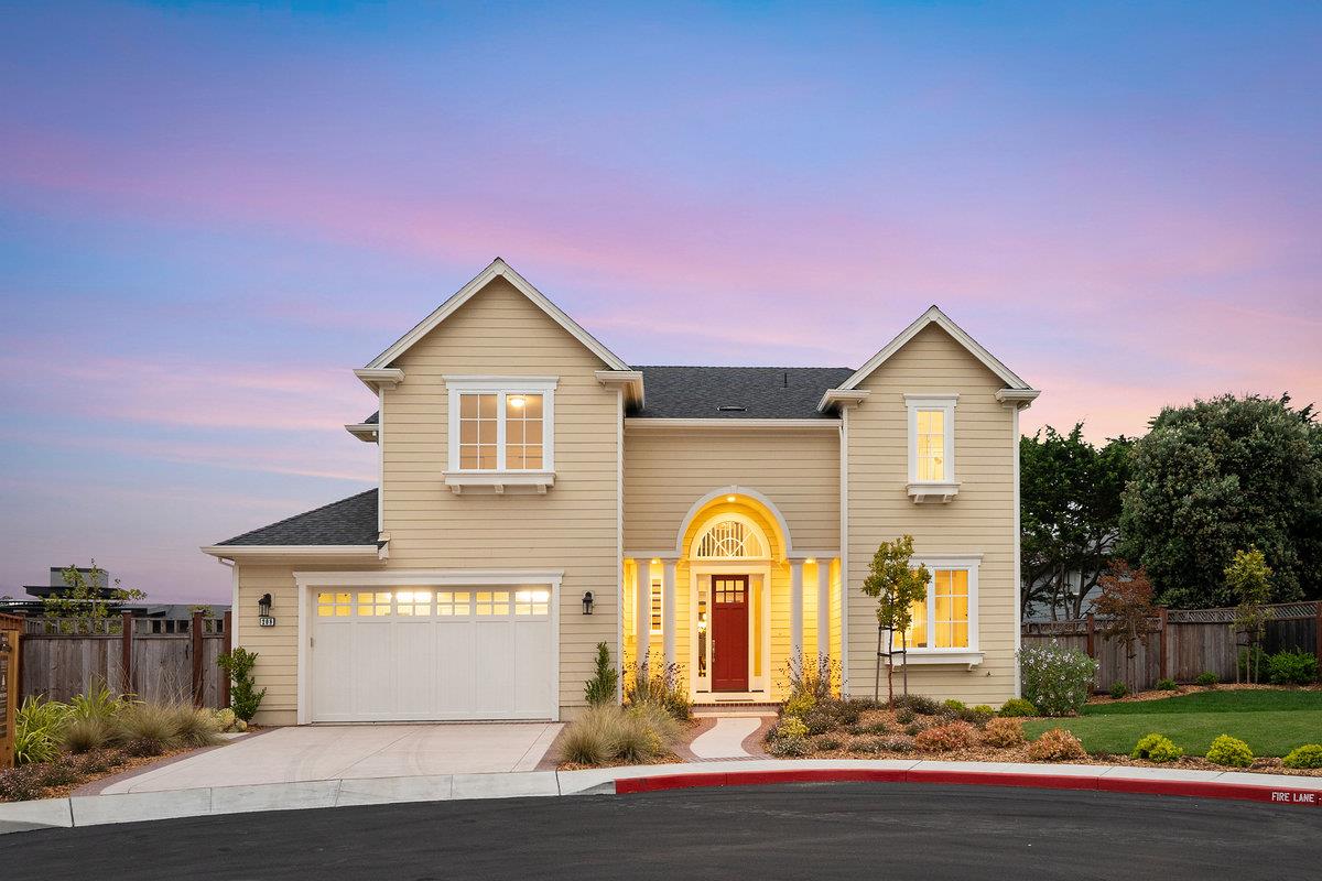 a front view of a house with a garden