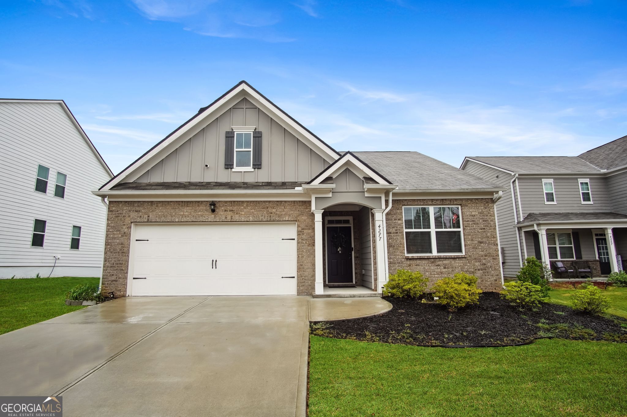 a front view of a house with a yard and garage