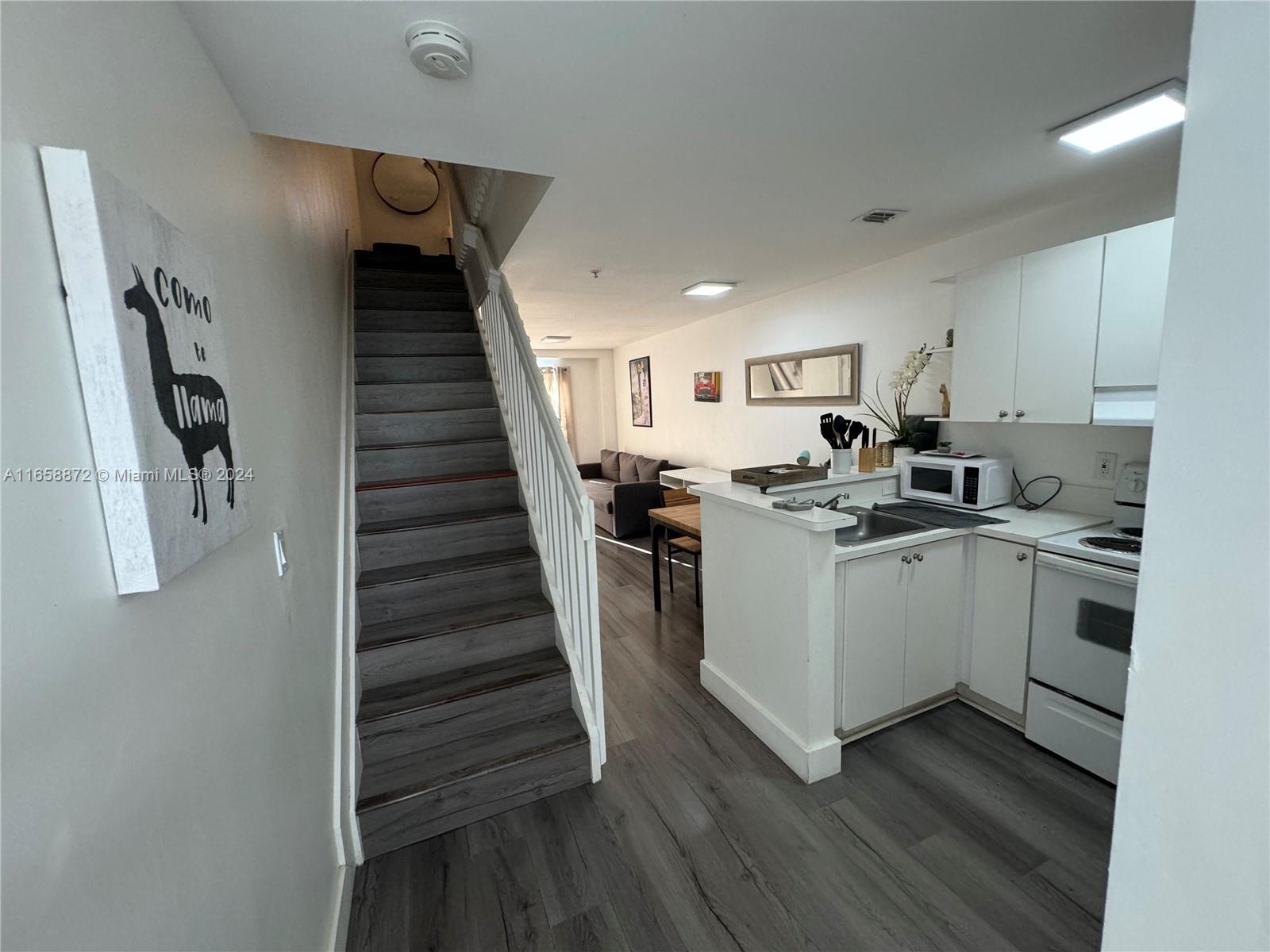 a view of a kitchen with electric appliances