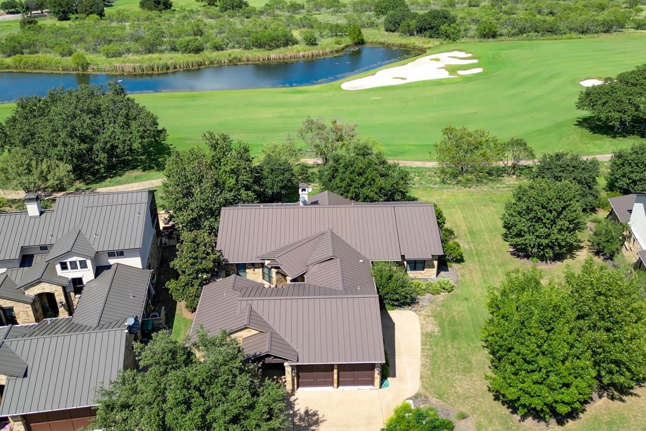 an aerial view of a house with garden space and lake view