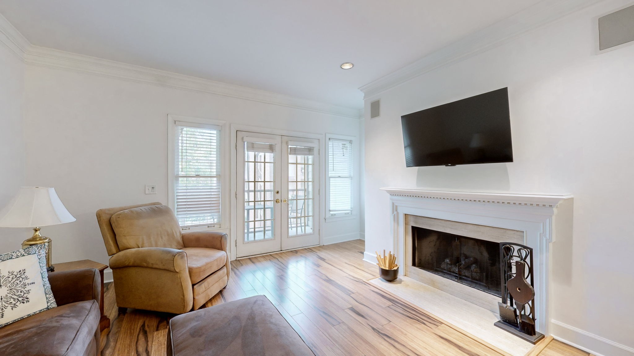 a living room with furniture a flat screen tv and a fireplace