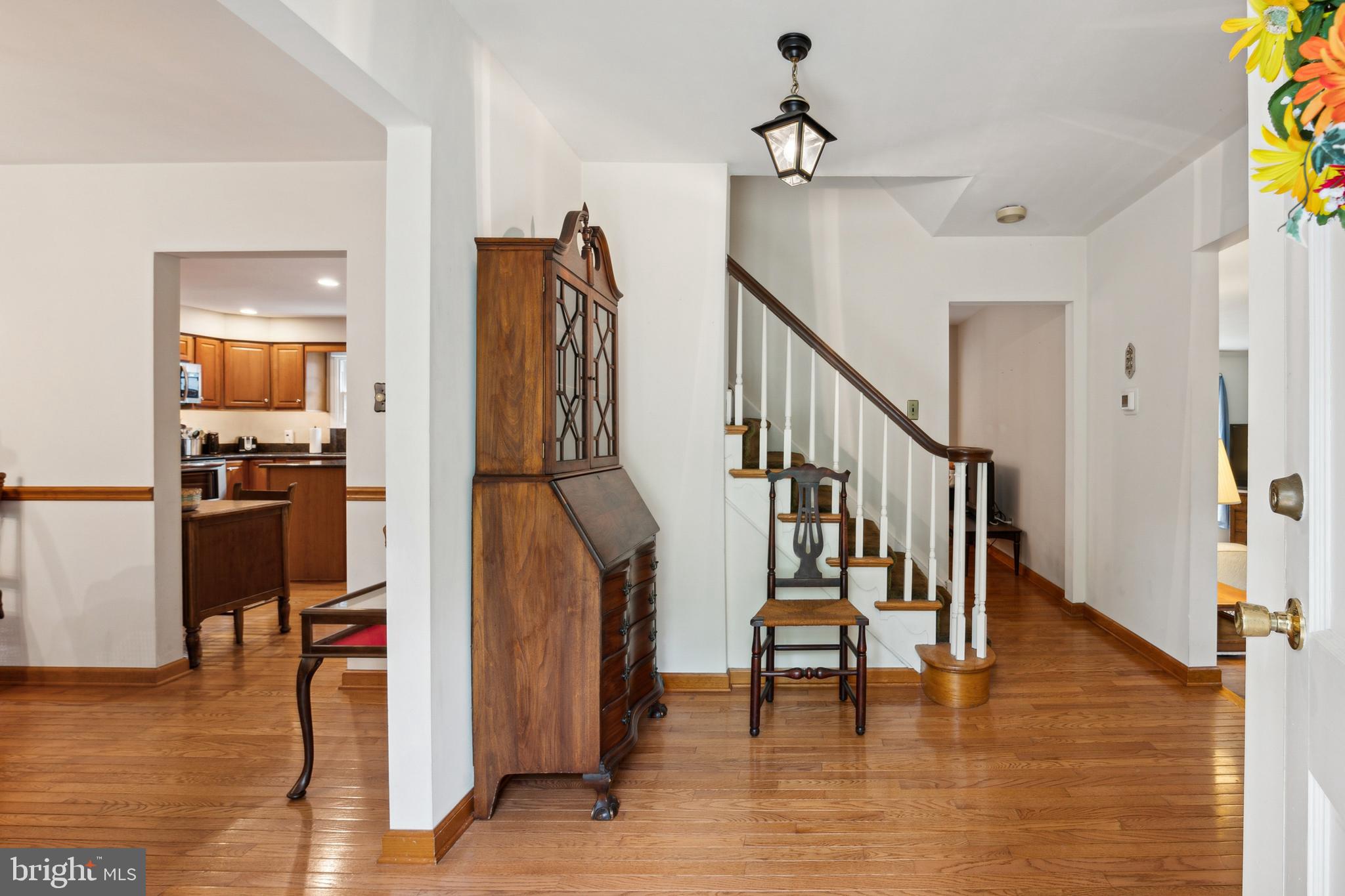 a view of entryway and hall with wooden floor