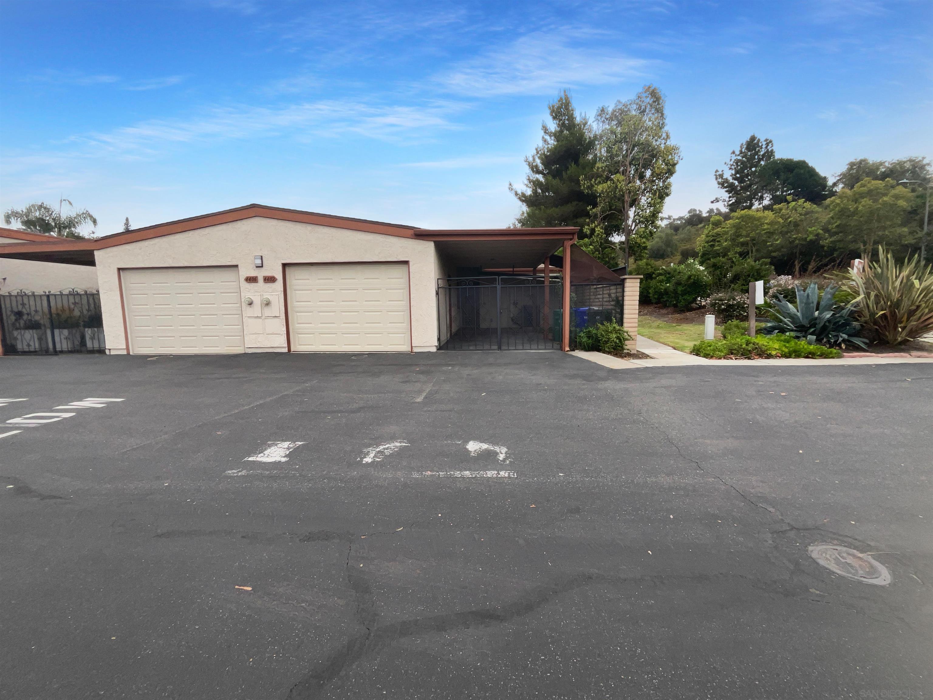 a view of a house with garage and plants