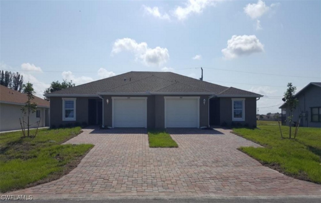 a front view of a house with a yard and garage