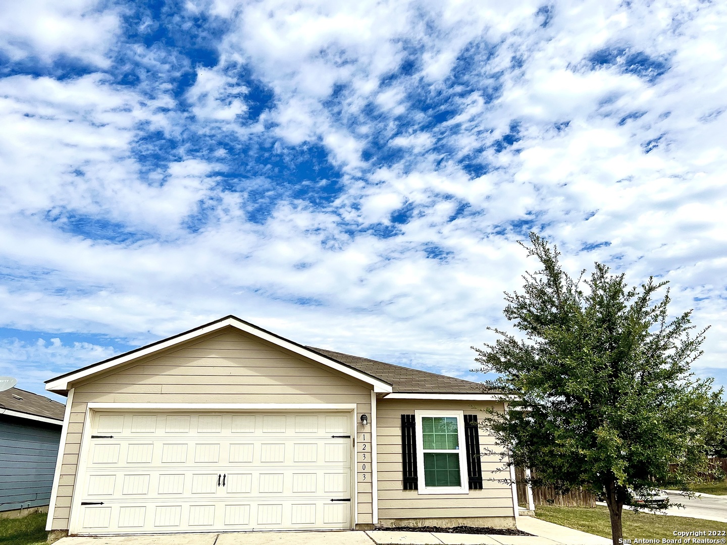 a view of a house with a small yard