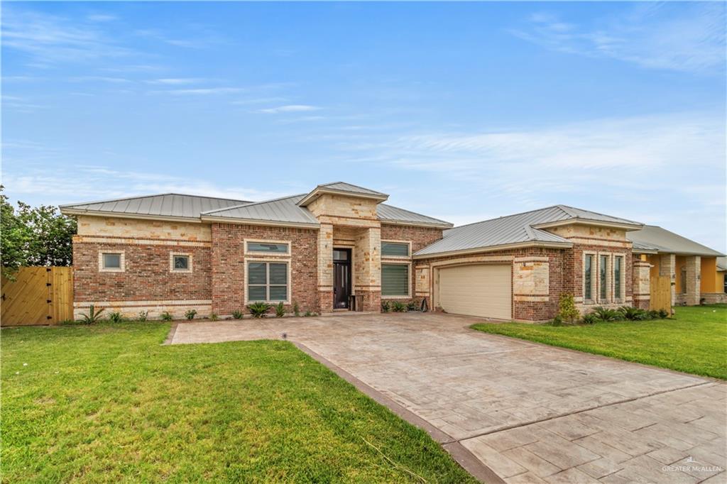 a front view of a house with a yard and outdoor seating