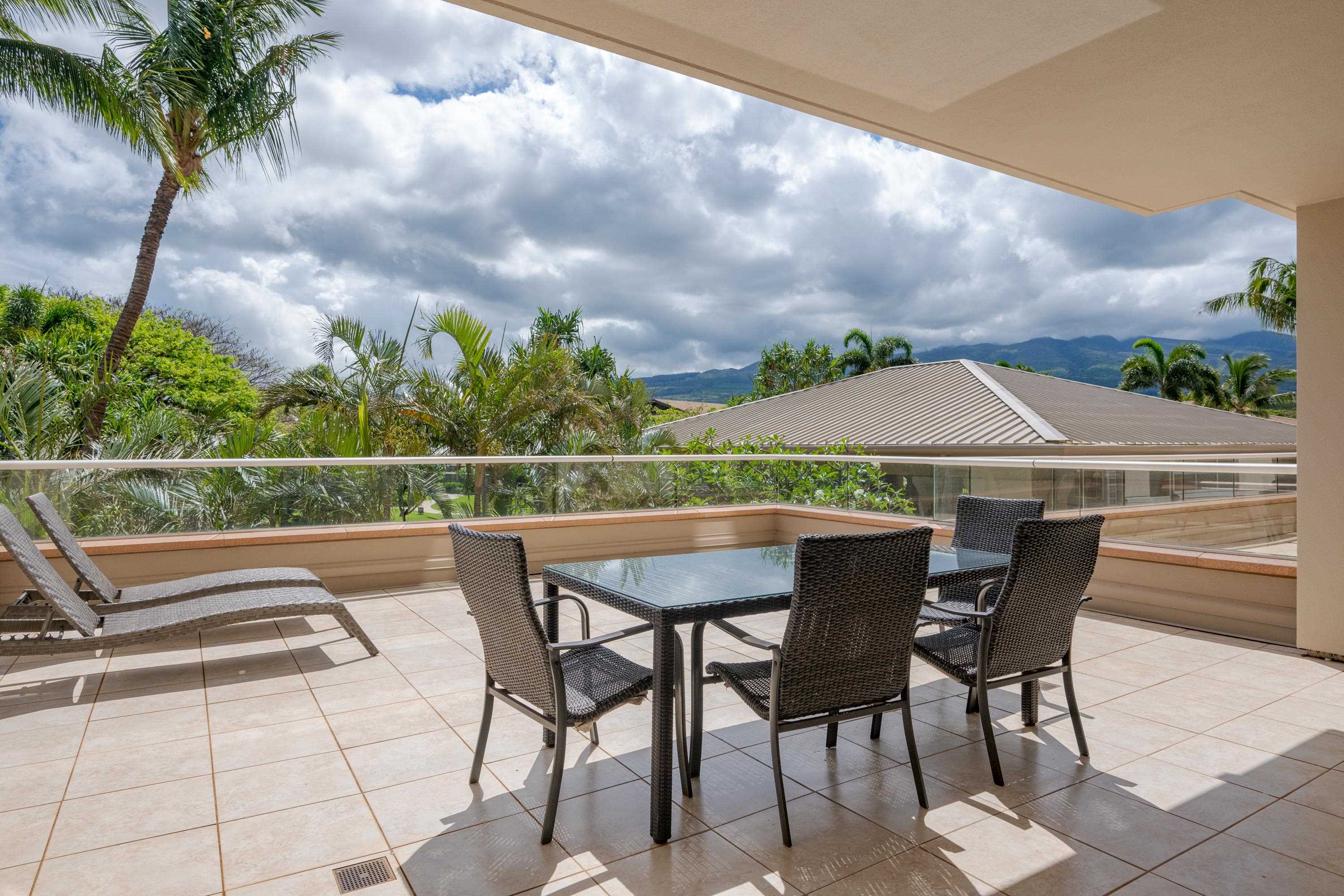 a view of backyard with seating space and trees