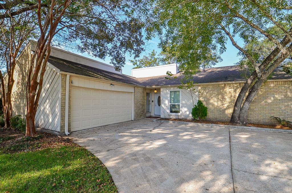 a view of a house with a yard and garage