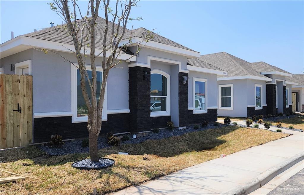 a front view of a house with a yard