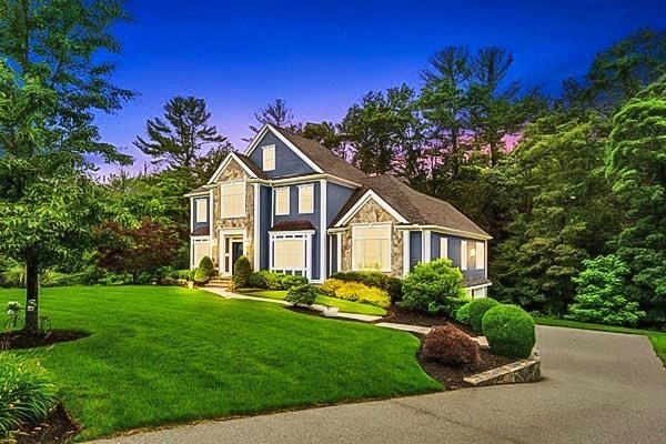 a front view of a house with a garden