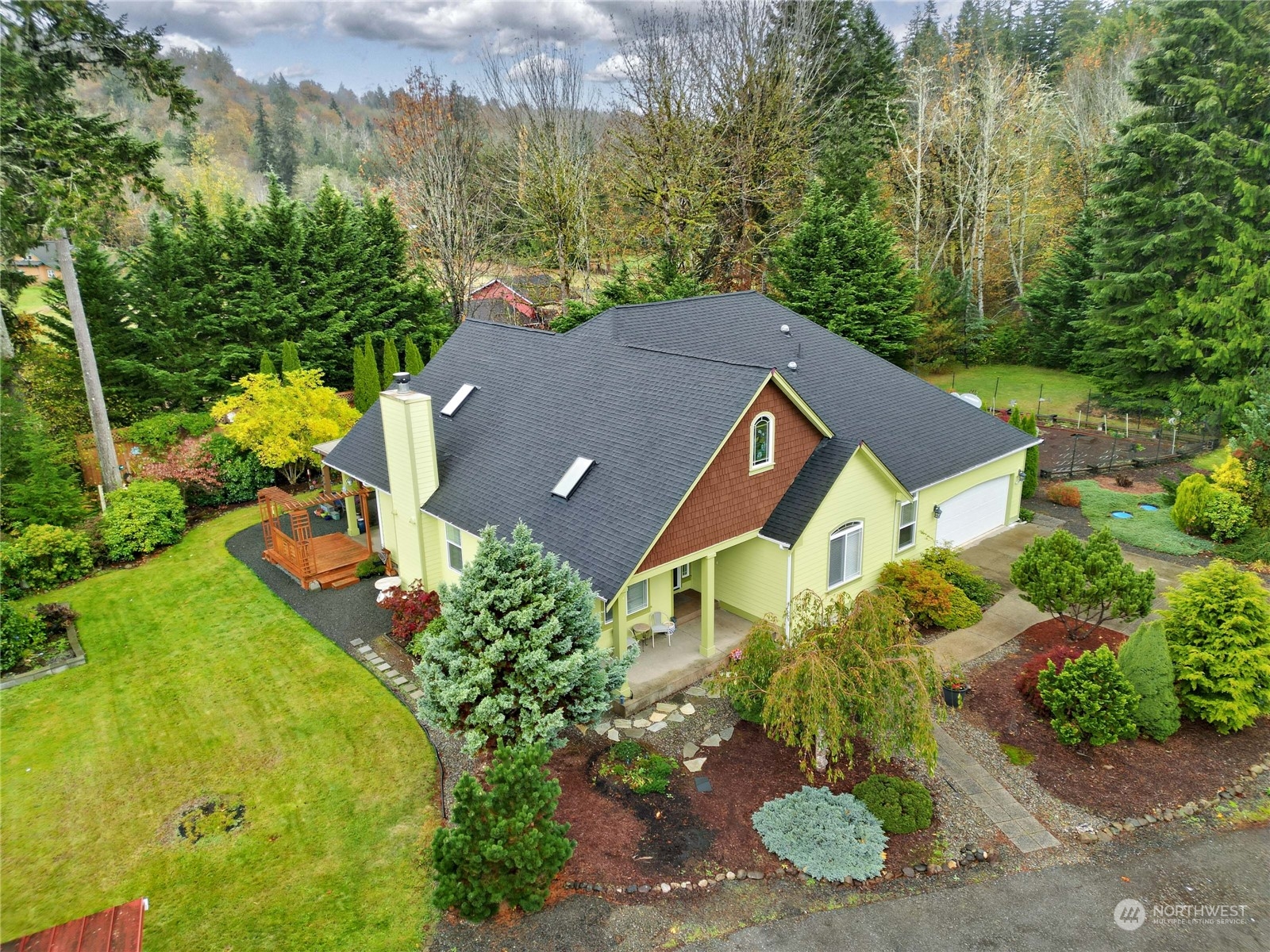 an aerial view of a house with yard swimming pool and outdoor seating