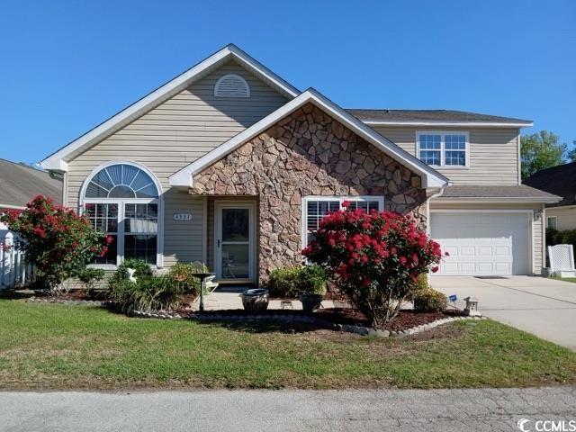 Front of property with a front lawn and a garage