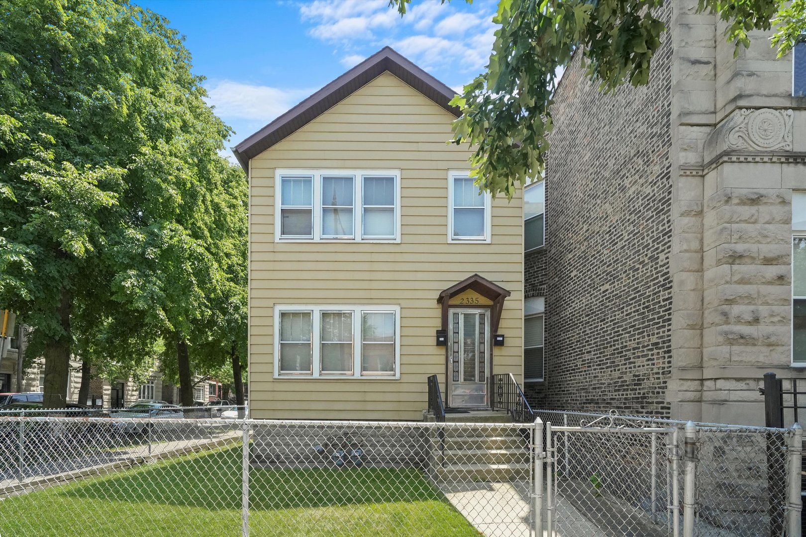 a front view of a house with a iron fence