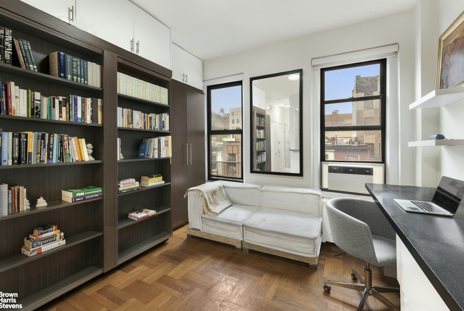 a bedroom with bed furniture and a book shelf