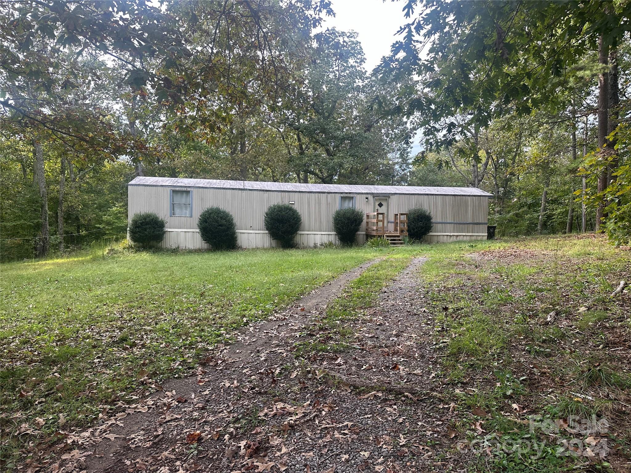 a view of a house with yard and sitting area