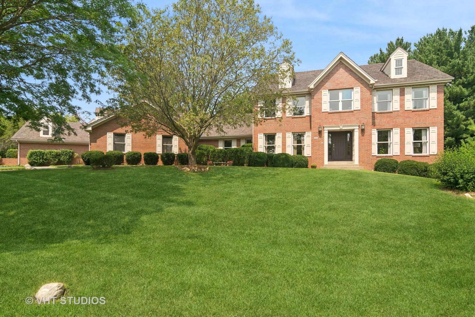 a front view of a house with a garden