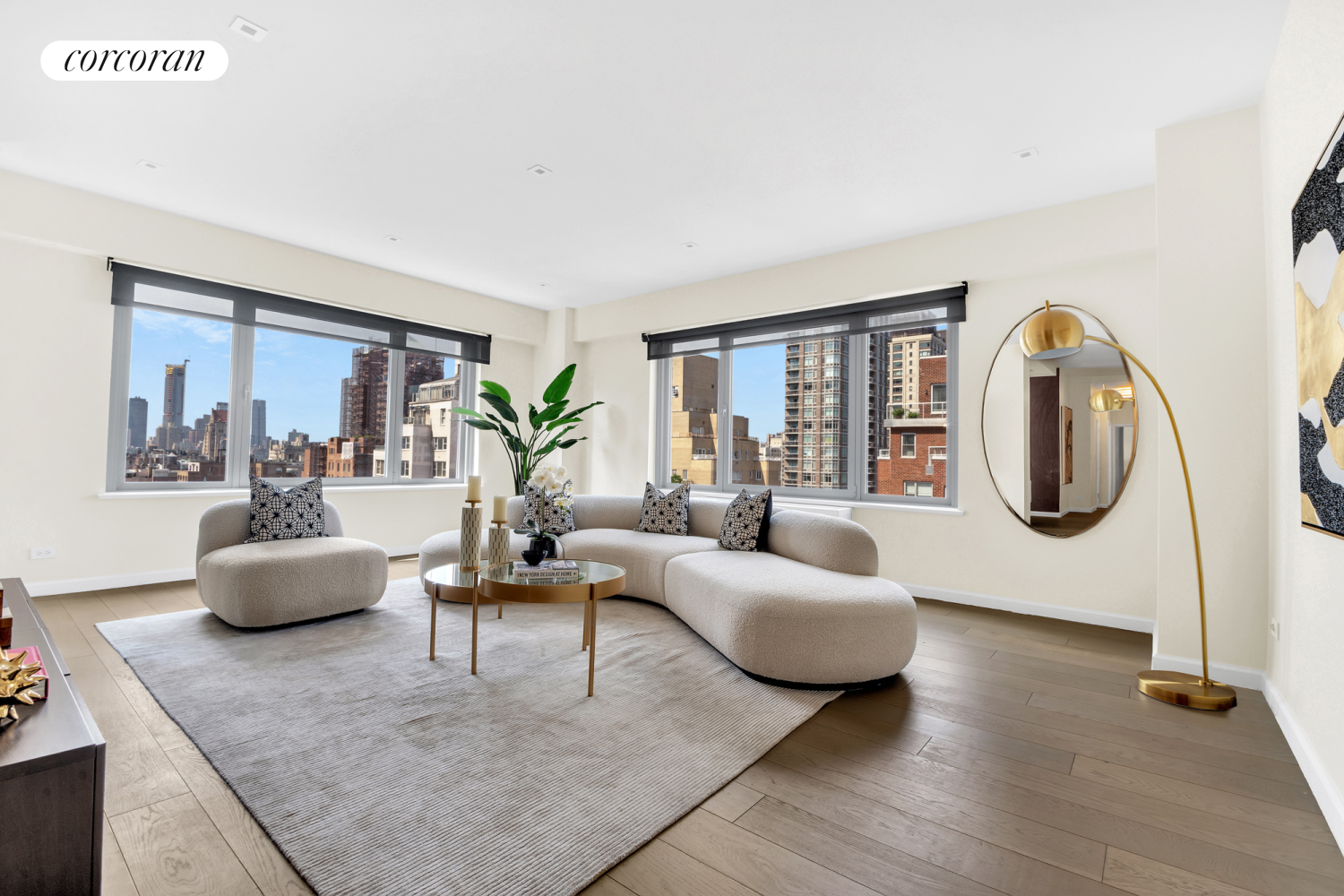 a living room with furniture a large window and a potted plant