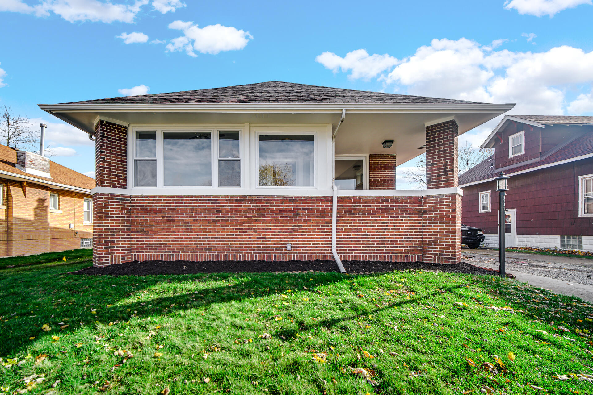 a view of a house with a yard and sitting area