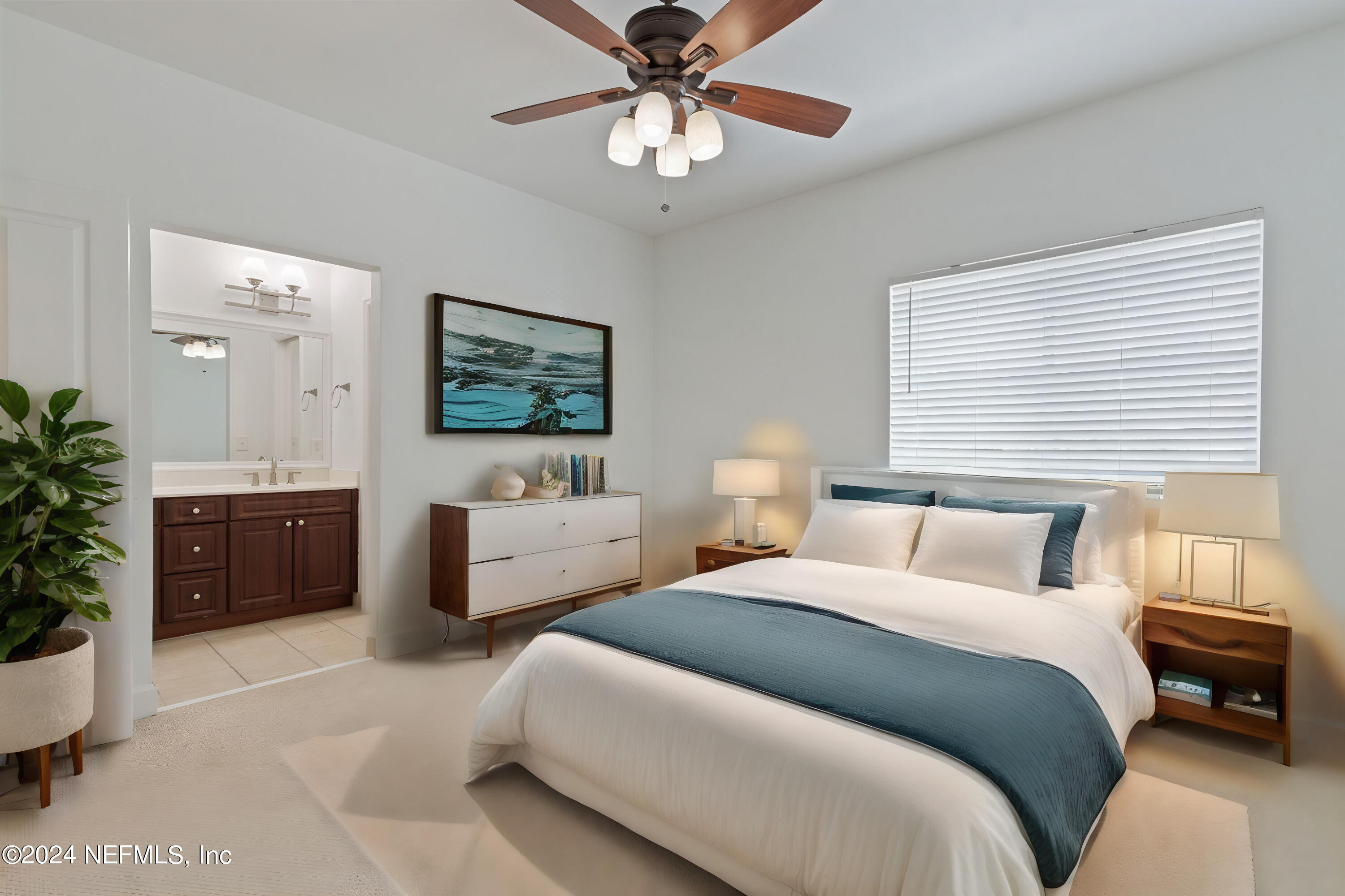 a bedroom with two beds and a chandelier