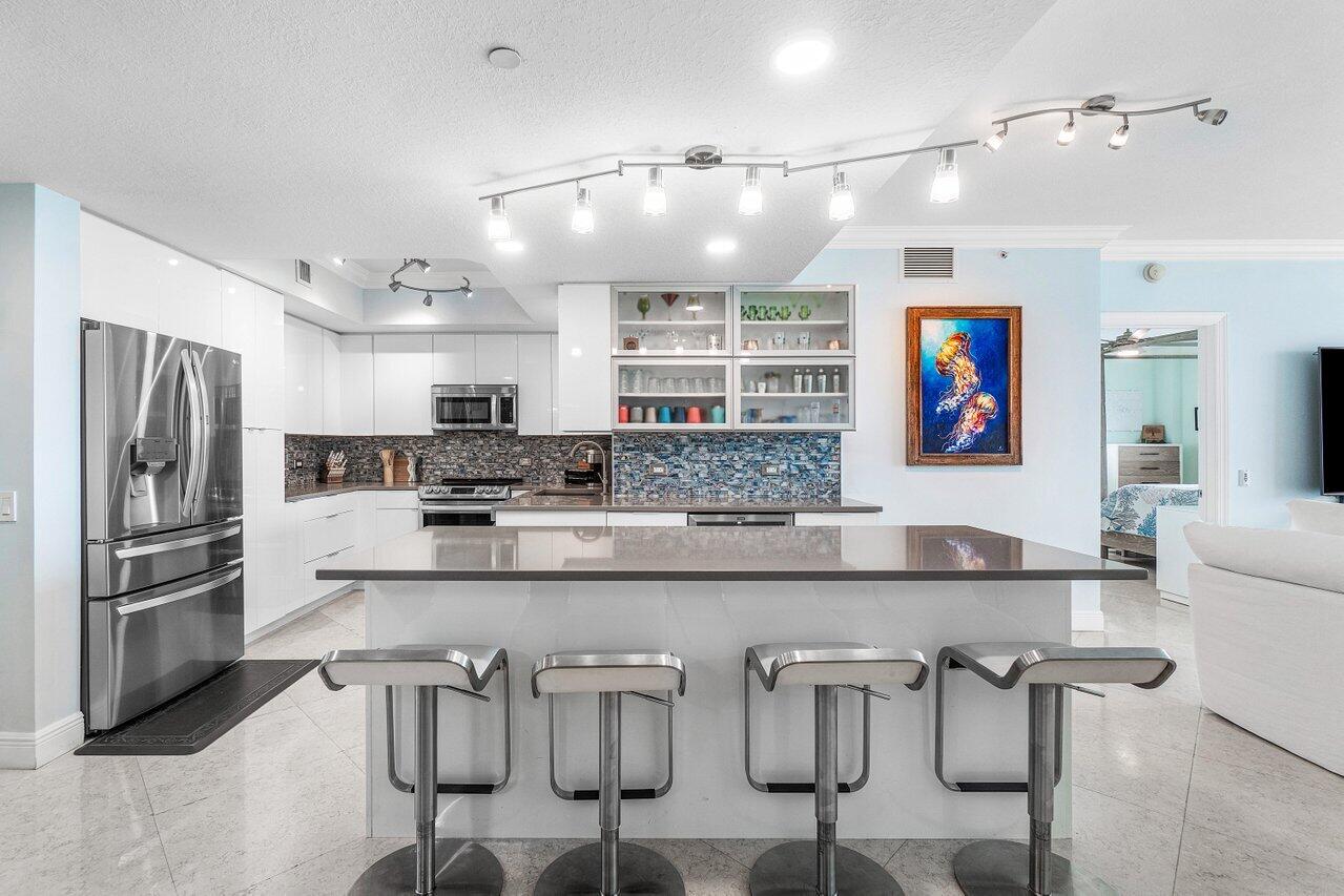 a kitchen with kitchen island granite countertop a table and chairs in it