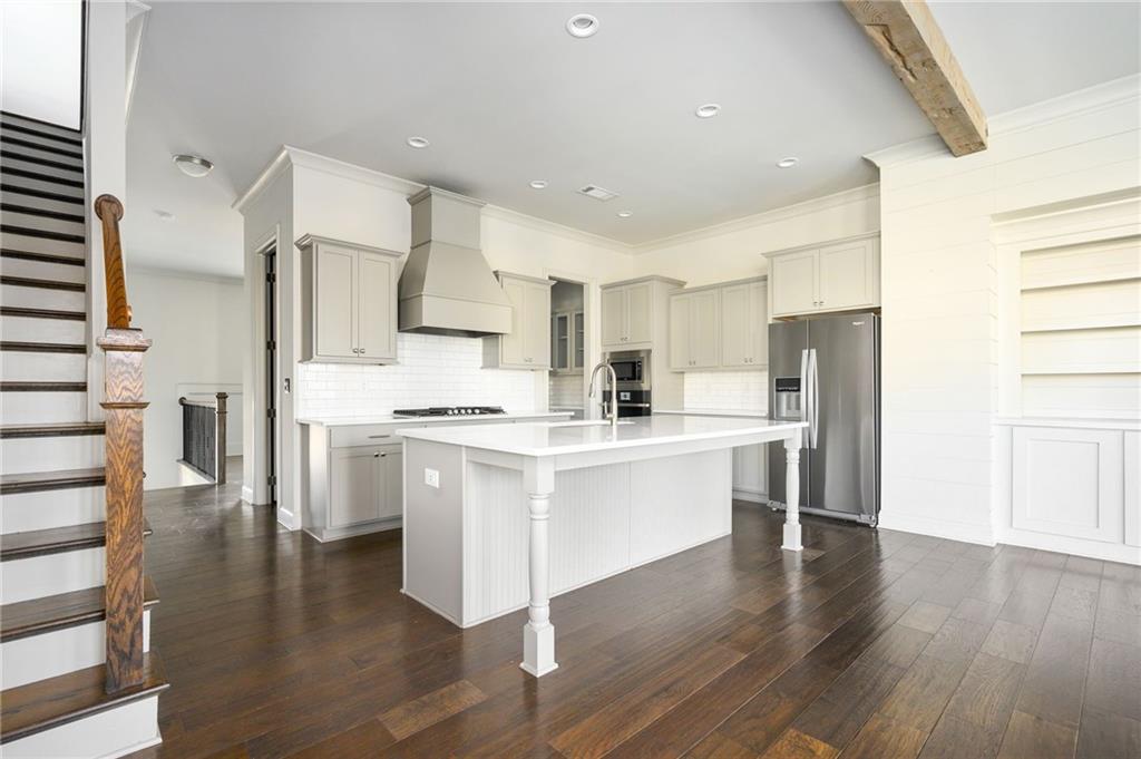 a kitchen with white cabinets and stainless steel appliances