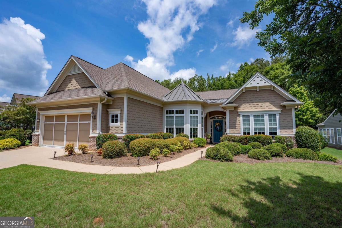 a front view of house with yard and green space