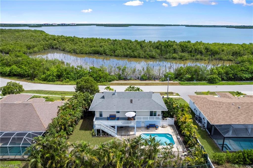 an aerial view of a house with garden space and outdoor seating