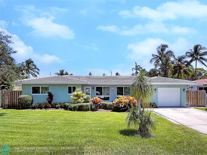 a front view of house with yard and outdoor seating