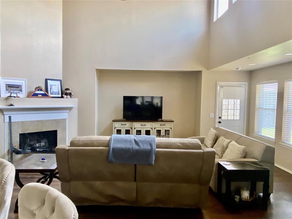 a living room with furniture a flat screen tv and a fireplace