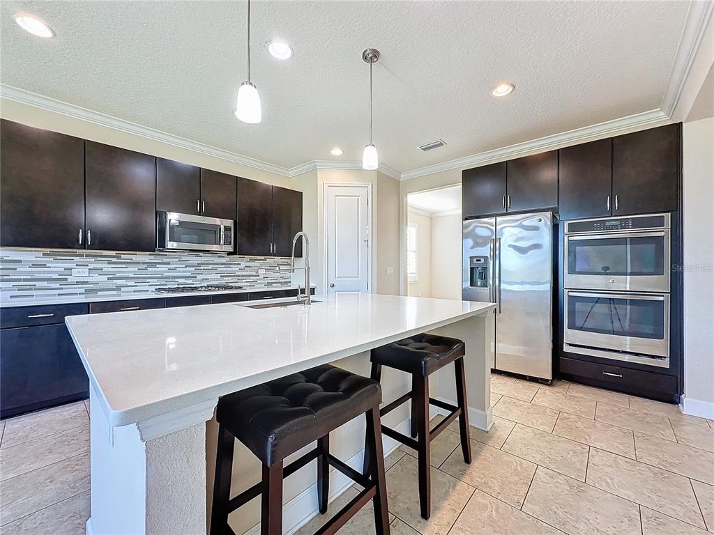 a large kitchen with a table and chairs