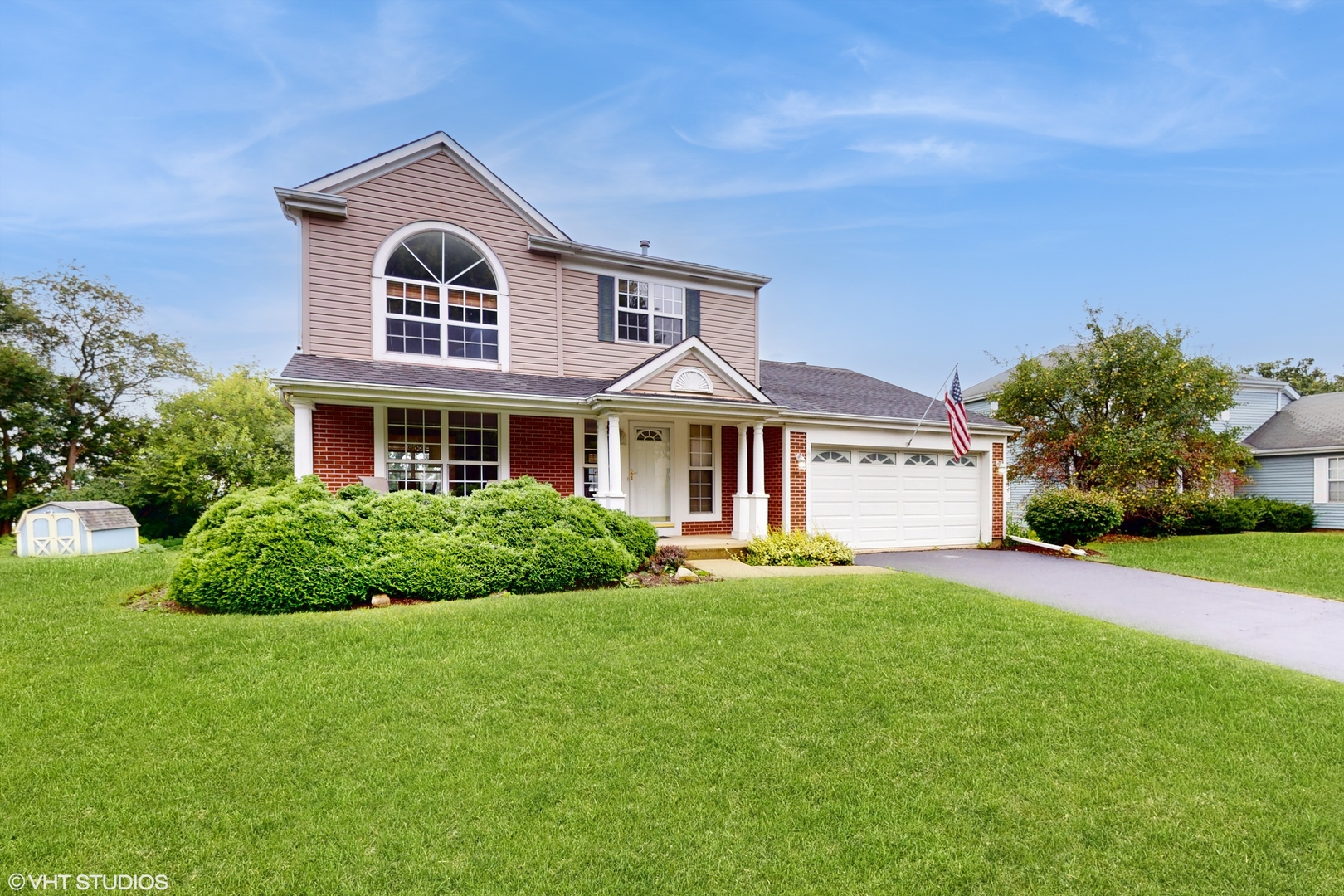 a front view of a house with a yard and garage