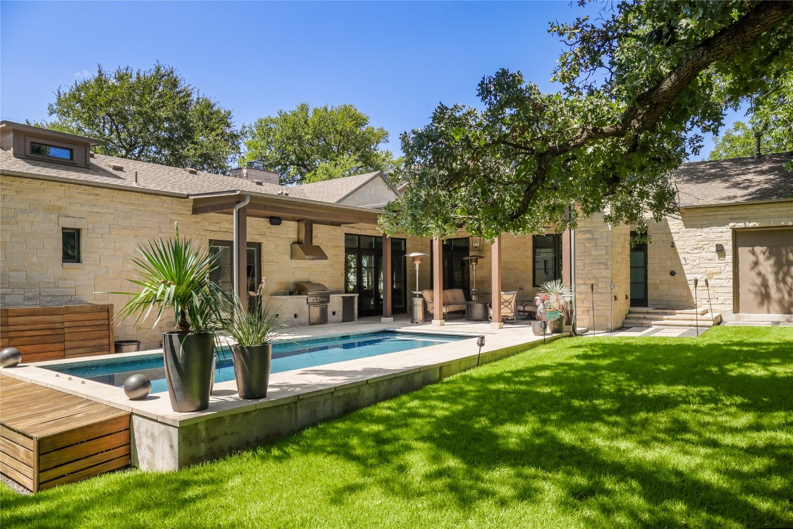 a view of a house with backyard sitting area and garden