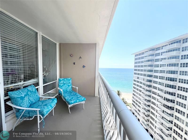 a view of a balcony with chairs