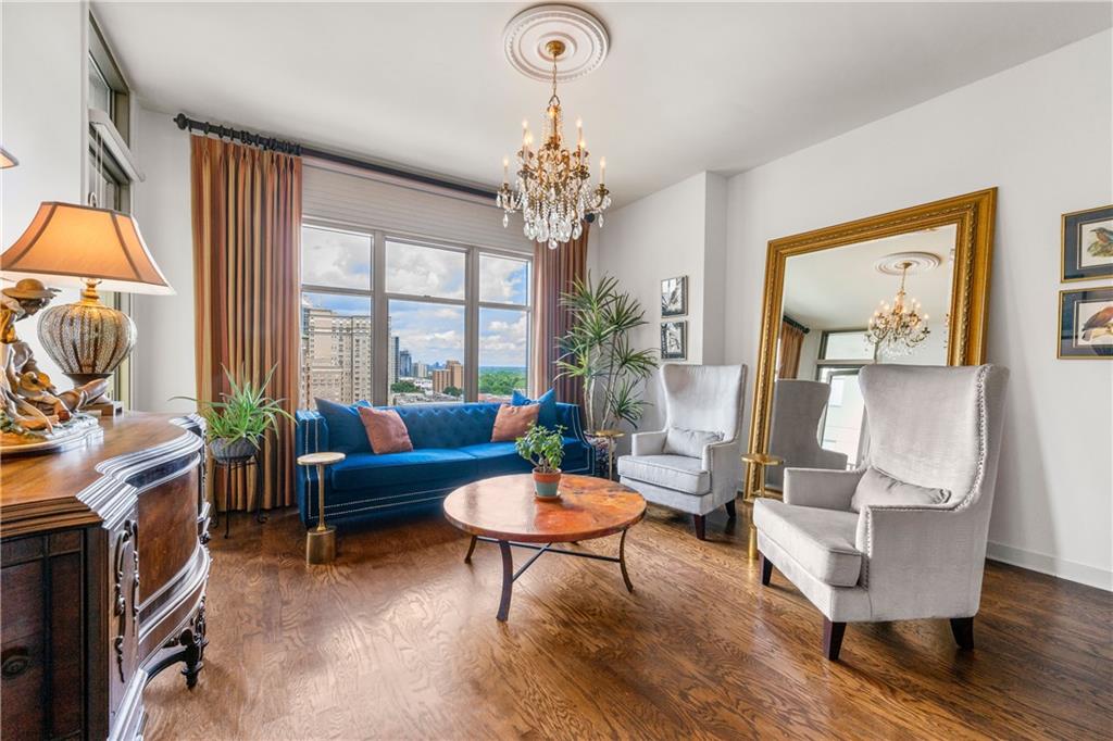 a living room with furniture and a chandelier