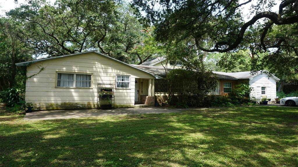 a front view of house with yard and green space