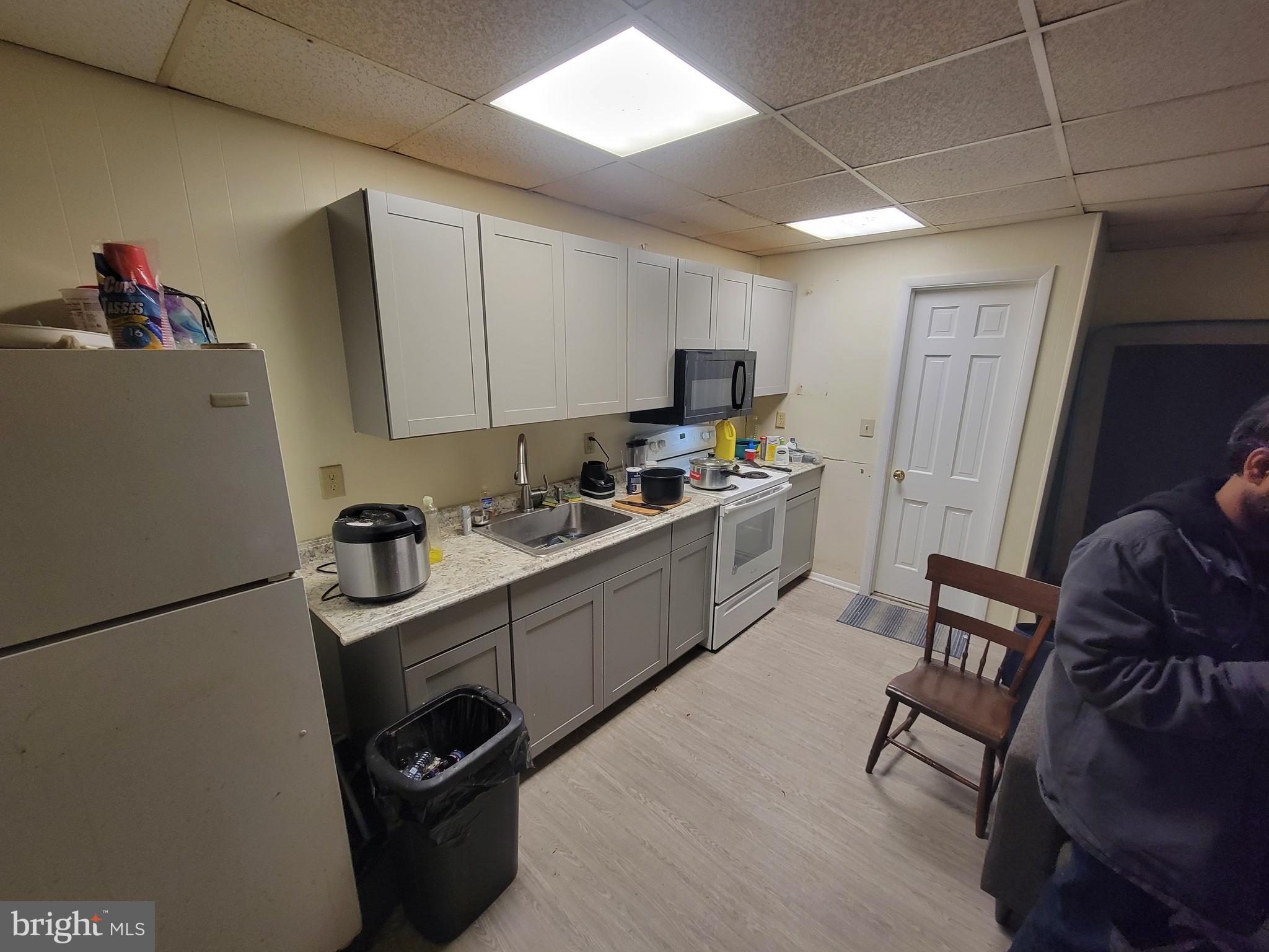 a kitchen with a sink appliances and cabinets