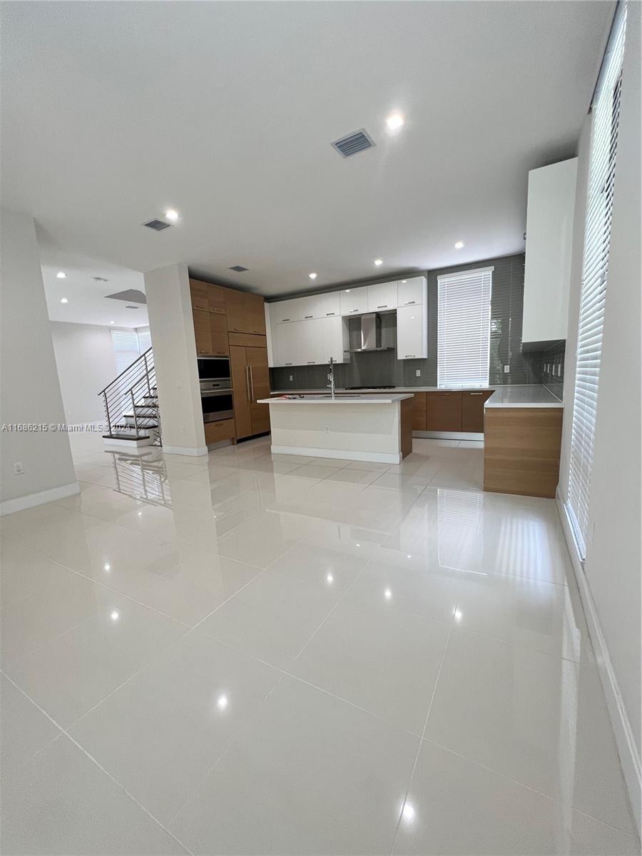 a view of kitchen with kitchen island microwave and stove