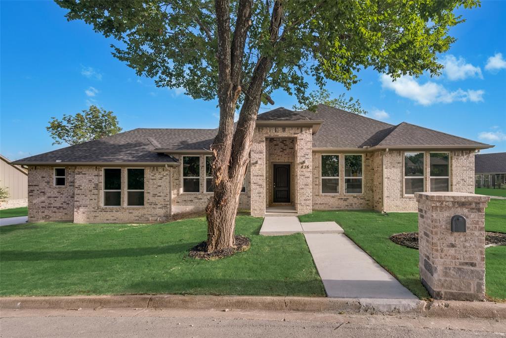 a front view of a house with a yard