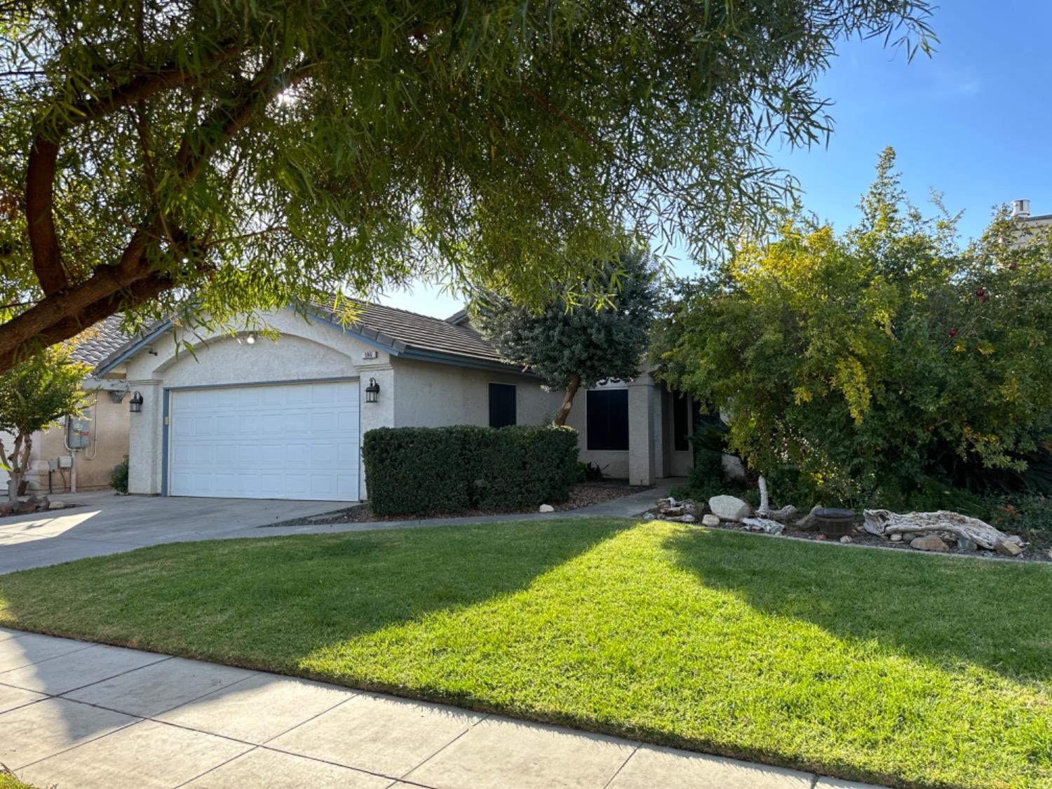 a front view of house with yard and green space