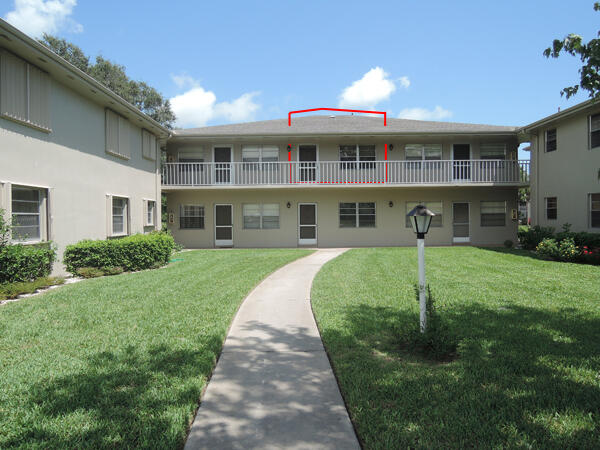 a front view of a residential apartment building with a yard