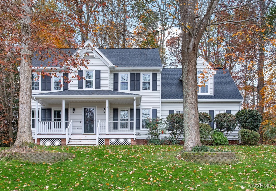 View of front of house with covered porch and a fr