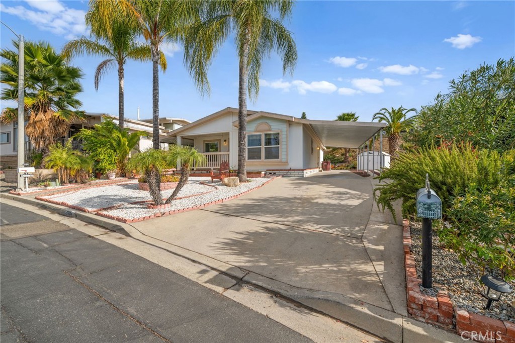 a front view of a house with palm trees