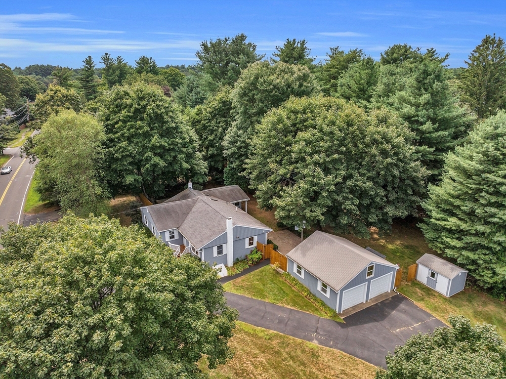 an aerial view of a house with a yard