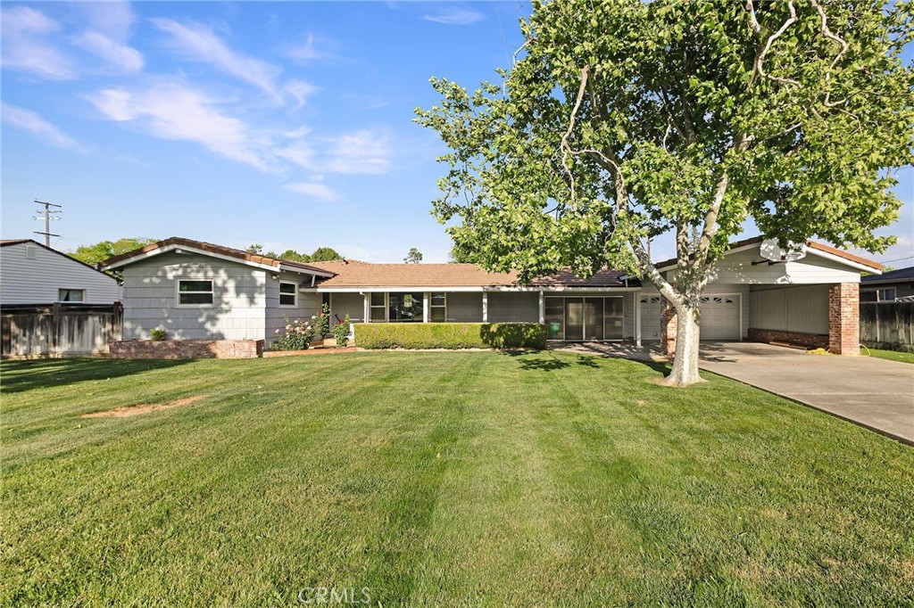 a front view of a house with a garden