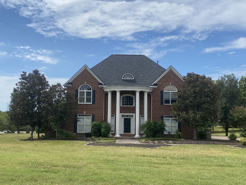 a front view of a house with a yard