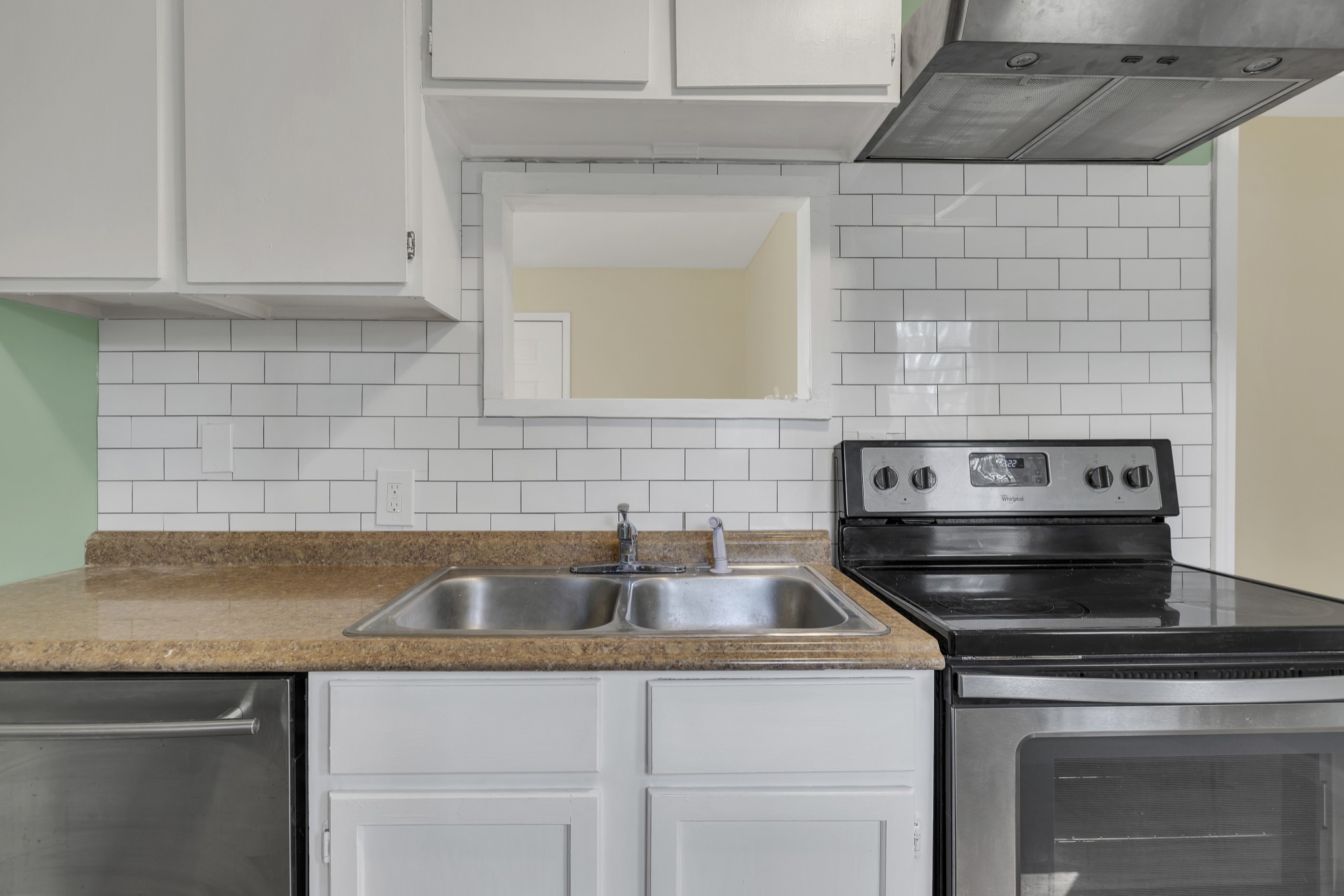 a kitchen with sink a stove and cabinets