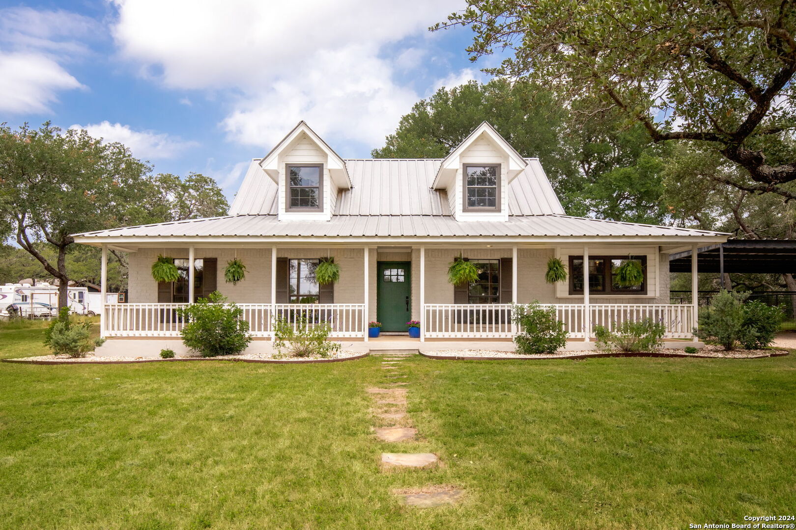 a front view of a house with a yard table and chairs