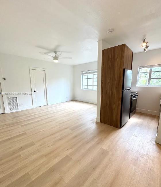 a view of a livingroom with a dishwasher cabinets and wooden floor