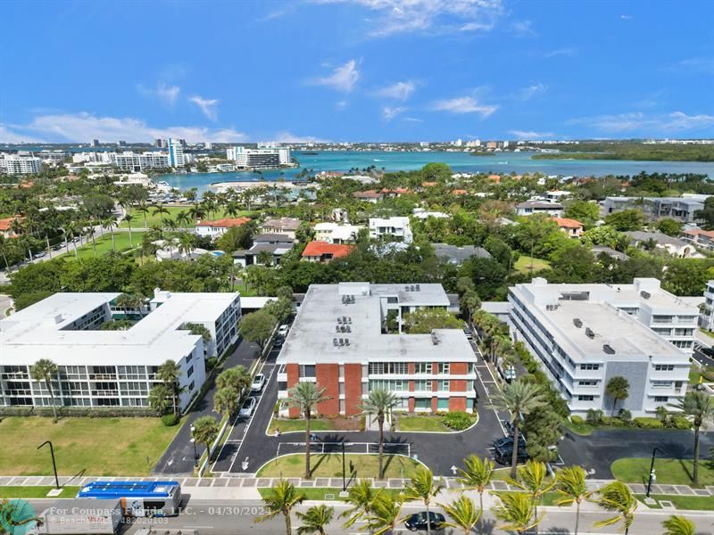 an aerial view of residential houses with outdoor space and swimming pool