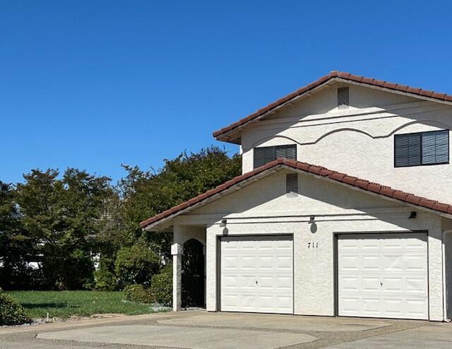 a front view of a house with garage